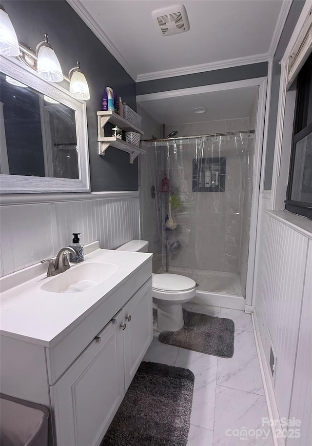 605 Impala Dr, Albemarle, NC 28001 - bathroom featuring marble look tile flooring, a stall shower, ornamental molding, vanity, and wainscoting
