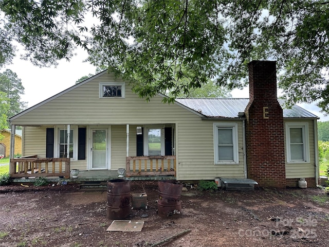 30497 Orchard Ln, Albemarle, NC 28001 - view of front of house featuring covered porch, a chimney, and a metal roof