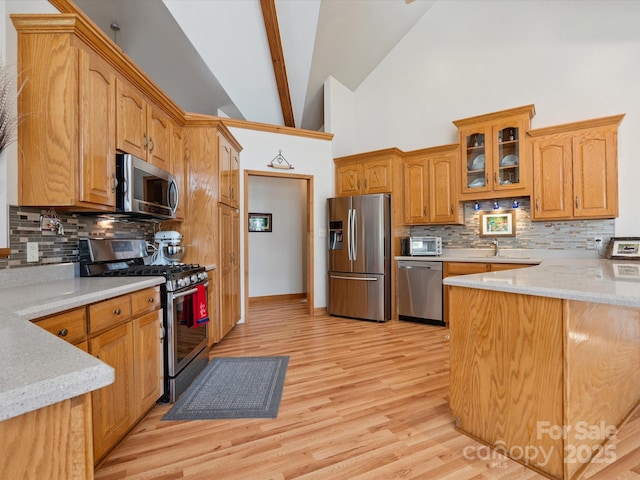 887 Living Waters Dr, Great Falls, SC 29055 - kitchen with appliances with stainless steel finishes, backsplash, light wood finished floors, glass insert cabinets, and high vaulted ceiling