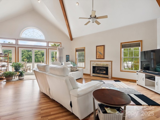 887 Living Waters Dr, Great Falls, SC 29055 - living area with light wood-type flooring, plenty of natural light, ceiling fan, a tiled fireplace, and high vaulted ceiling