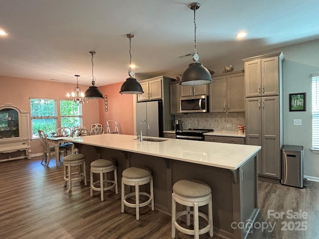 284 Old Harbor Dr, Mount Gilead, NC 27306 - kitchen with appliances with stainless steel finishes, dark wood-style flooring, a spacious island, light countertops, and recessed lighting