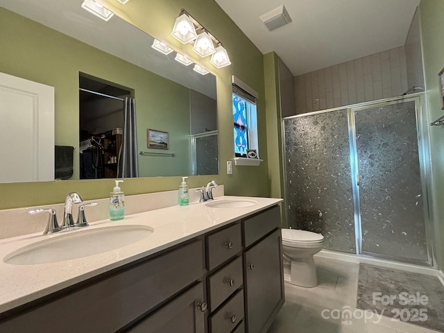 284 Old Harbor Dr, Mount Gilead, NC 27306 - bathroom featuring a stall shower, double vanity, a spacious closet, and tile patterned flooring