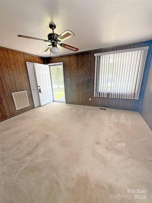 3412 1st Avenue Cir NW, Hickory, NC 28601 - carpeted empty room with wood walls and ceiling fan
