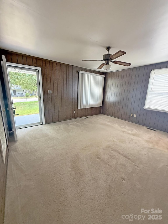 3412 1st Avenue Cir NW, Hickory, NC 28601 - carpeted empty room featuring wooden walls and ceiling fan