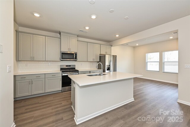 1434 31st St NE, Conover, NC 28613 - kitchen featuring stainless steel appliances, gray cabinetry, backsplash, an island with sink, and recessed lighting