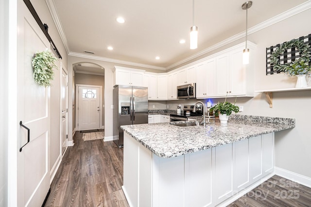 2526 Snow Creek Rd NE, Hickory, NC 28601 - kitchen with stainless steel appliances, a peninsula, arched walkways, white cabinets, and crown molding