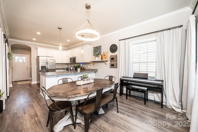 2526 Snow Creek Rd NE, Hickory, NC 28601 - dining area with arched walkways, dark wood finished floors, ornamental molding, and recessed lighting