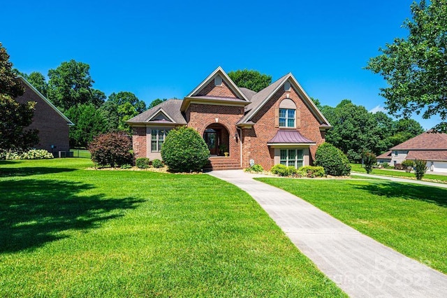 1083 Fox Chase Dr, Newton, NC 28658 - view of front of property with a front yard, brick siding, and a standing seam roof