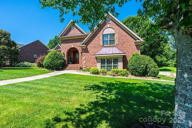 1083 Fox Chase Dr, Newton, NC 28658 - traditional-style house with brick siding, a front lawn, and a standing seam roof