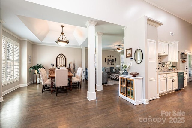 1083 Fox Chase Dr, Newton, NC 28658 - dining area featuring ornate columns, dark wood finished floors, a raised ceiling, crown molding, and a ceiling fan