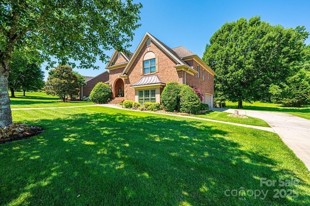 1083 Fox Chase Dr, Newton, NC 28658 - view of front of home featuring an attached garage, concrete driveway, a standing seam roof, a front lawn, and brick siding