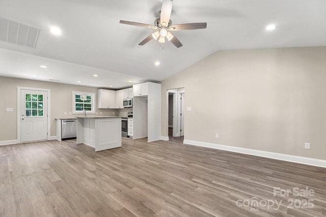 1234 Goodnight Ln, Kannapolis, NC 28081 - kitchen featuring appliances with stainless steel finishes, open floor plan, white cabinetry, a center island, and ceiling fan