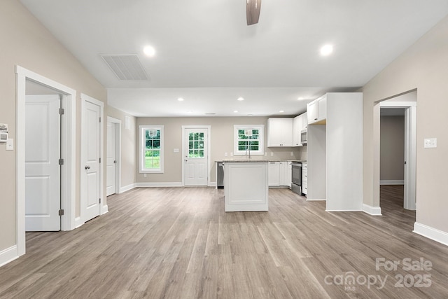 1234 Goodnight Ln, Kannapolis, NC 28081 - kitchen featuring stainless steel electric range, light wood-style flooring, white microwave, a kitchen island, and recessed lighting