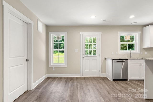 1234 Goodnight Ln, Kannapolis, NC 28081 - kitchen with dishwasher, light wood-style flooring, white cabinetry, light stone countertops, and recessed lighting