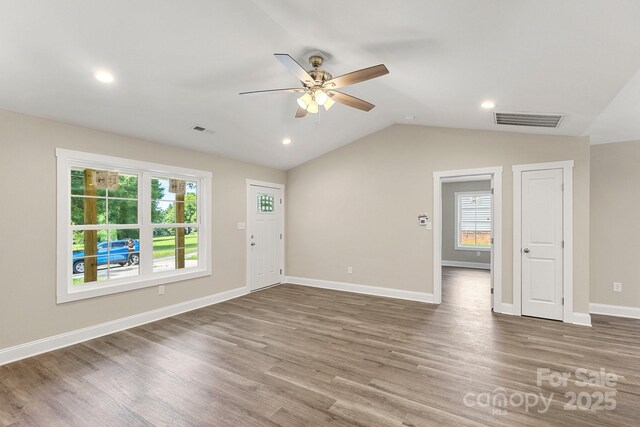 1234 Goodnight Ln, Kannapolis, NC 28081 - unfurnished living room with a ceiling fan, plenty of natural light, wood finished floors, vaulted ceiling, and recessed lighting