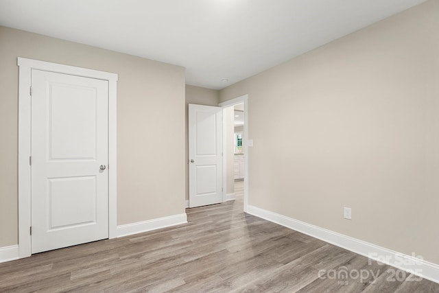 1234 Goodnight Ln, Kannapolis, NC 28081 - unfurnished bedroom featuring light wood-style flooring and baseboards