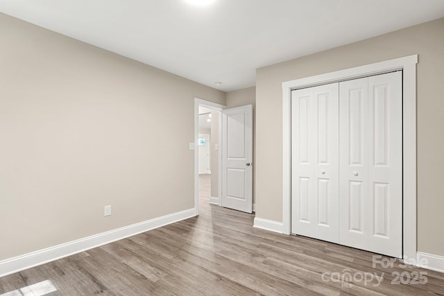 1234 Goodnight Ln, Kannapolis, NC 28081 - unfurnished bedroom featuring light wood finished floors and a closet