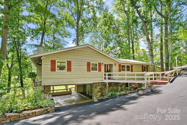 386 Country Club Dr Unit C6, Canton, NC 28716 - view of front of house with a carport, driveway, stone siding, and a chimney