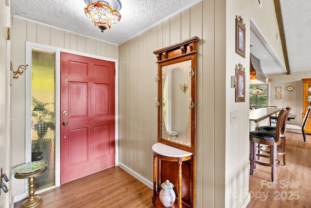 386 Country Club Dr Unit C6, Canton, NC 28716 - entrance foyer with wood finished floors, a textured ceiling, crown molding, and wood walls