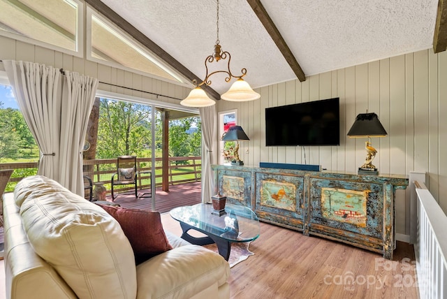 386 Country Club Dr Unit C6, Canton, NC 28716 - living area featuring beamed ceiling, a textured ceiling, plenty of natural light, wood finished floors, and wooden walls