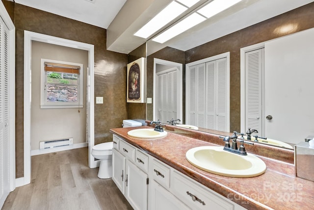 386 Country Club Dr Unit C6, Canton, NC 28716 - full bathroom featuring a closet, double vanity, wood finished floors, and baseboard heating