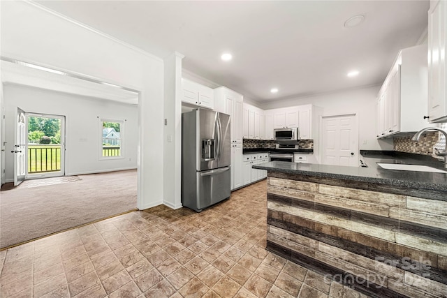 814 Carved Oak Ct, York, SC 29745 - kitchen featuring appliances with stainless steel finishes, dark countertops, light colored carpet, decorative backsplash, and recessed lighting