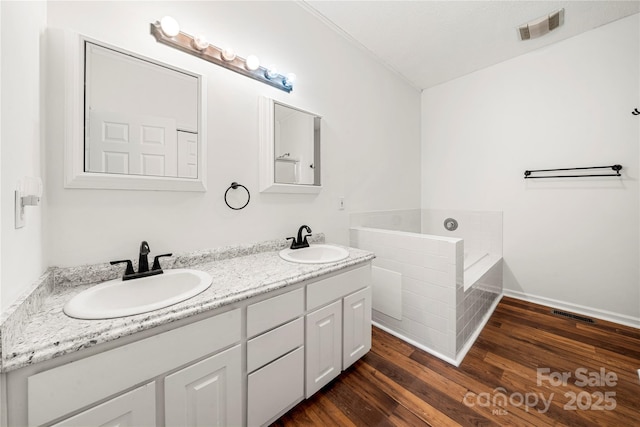 814 Carved Oak Ct, York, SC 29745 - full bath with double vanity, a garden tub, and wood finished floors