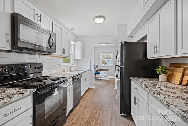 8012 Red Lantern Rd, Indian Trail, NC 28079 - kitchen with black appliances, light wood-style floors, and white cabinetry