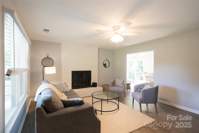 8012 Red Lantern Rd, Indian Trail, NC 28079 - living area featuring wood finished floors, a ceiling fan, and a brick fireplace