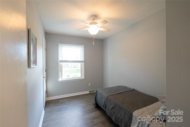 8012 Red Lantern Rd, Indian Trail, NC 28079 - bedroom featuring dark wood-type flooring, a textured ceiling, and a ceiling fan