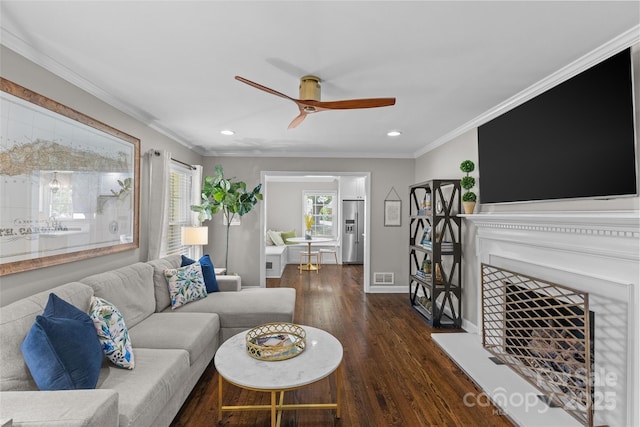 5501 Murrayhill Rd, Charlotte, NC 28210 - living room featuring a ceiling fan, recessed lighting, dark wood-type flooring, crown molding, and a fireplace