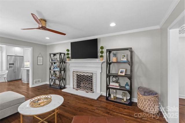 5501 Murrayhill Rd, Charlotte, NC 28210 - living area featuring ceiling fan, dark wood finished floors, recessed lighting, ornamental molding, and a tiled fireplace