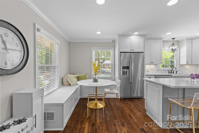 5501 Murrayhill Rd, Charlotte, NC 28210 - kitchen with high quality fridge, ornamental molding, plenty of natural light, dark wood finished floors, and light countertops