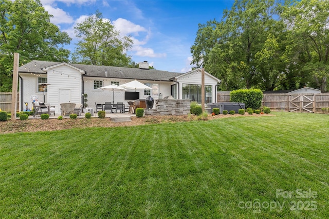 5501 Murrayhill Rd, Charlotte, NC 28210 - rear view of house featuring a hot tub, a patio, a fenced backyard, and a chimney