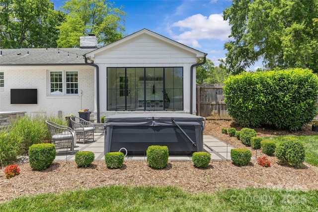 5501 Murrayhill Rd, Charlotte, NC 28210 - rear view of house featuring a hot tub, a chimney, a patio, and brick siding