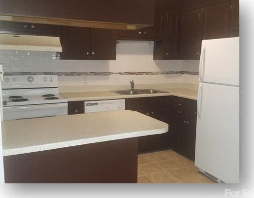 153 W End St, Chester, SC 29706 - kitchen featuring white appliances, ventilation hood, light countertops, dark brown cabinets, and decorative backsplash