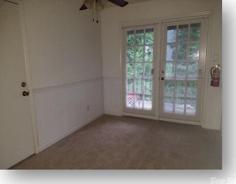 153 W End St, Chester, SC 29706 - empty room with a ceiling fan, carpet, and a wainscoted wall