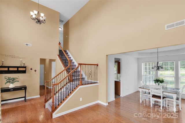2004 Onotoa Dr, Indian Trail, NC 28079 - stairway featuring a chandelier, wood finished floors, and a towering ceiling