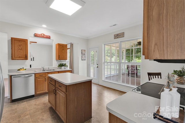 2004 Onotoa Dr, Indian Trail, NC 28079 - kitchen featuring dishwasher, light countertops, a center island, recessed lighting, and brown cabinetry