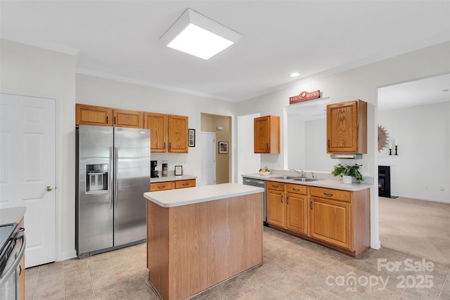 2004 Onotoa Dr, Indian Trail, NC 28079 - kitchen featuring stainless steel appliances, light countertops, a center island, crown molding, and brown cabinets