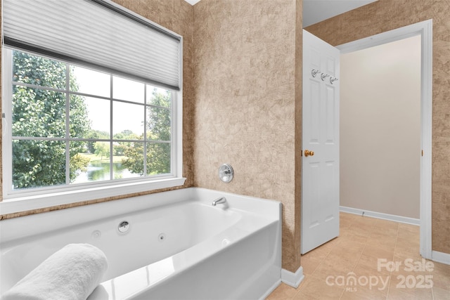 2004 Onotoa Dr, Indian Trail, NC 28079 - bathroom with plenty of natural light, a tub with jets, and tile patterned flooring