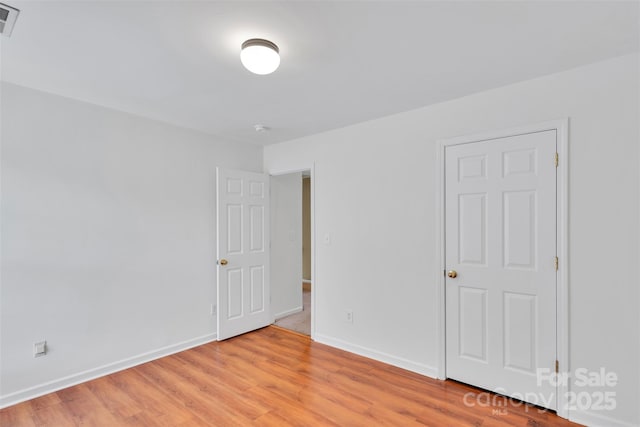 2004 Onotoa Dr, Indian Trail, NC 28079 - empty room featuring light wood-style floors and a smoke detector