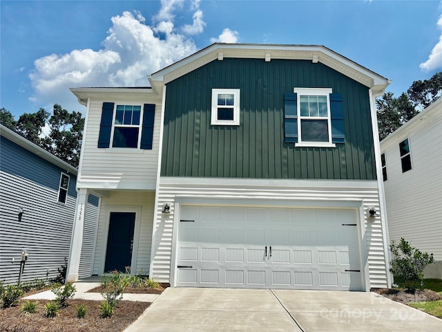 1358 31st St NE, Conover, NC 28613 - view of front facade with board and batten siding, a garage, and driveway