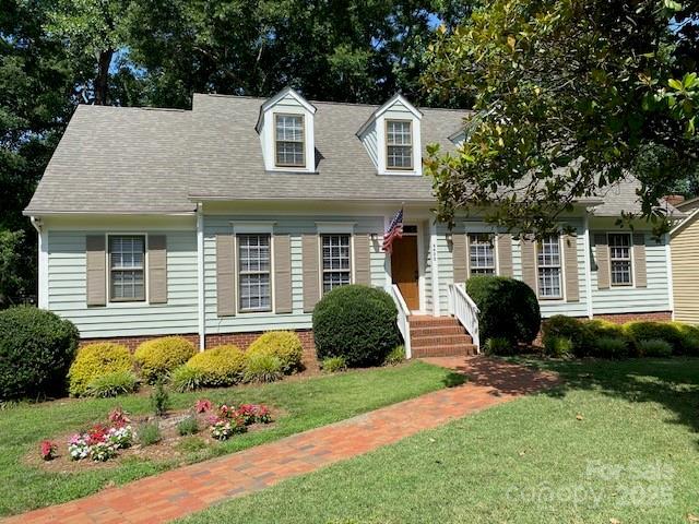 6632 Summer Darby Ln, Charlotte, NC 28270 - cape cod house featuring a front yard and roof with shingles