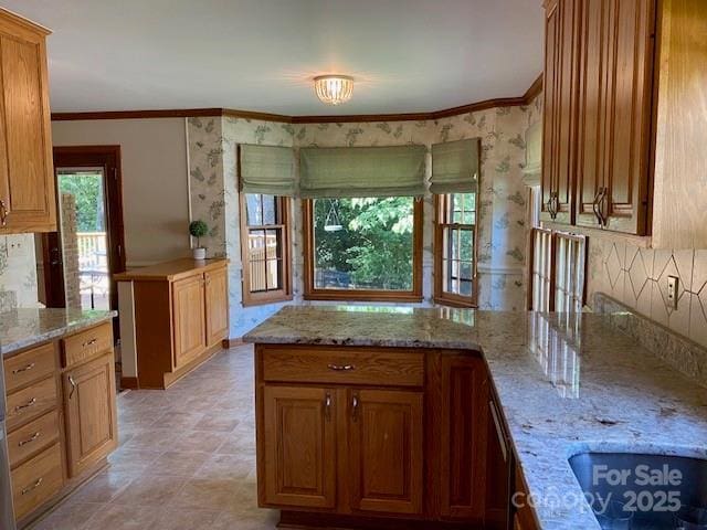 6632 Summer Darby Ln, Charlotte, NC 28270 - kitchen featuring light stone counters, tasteful backsplash, crown molding, a peninsula, and brown cabinets