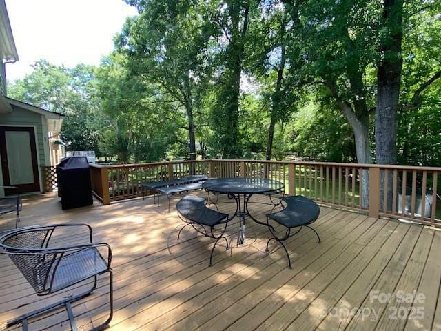 6632 Summer Darby Ln, Charlotte, NC 28270 - deck featuring outdoor dining space, a grill, and view of scattered trees
