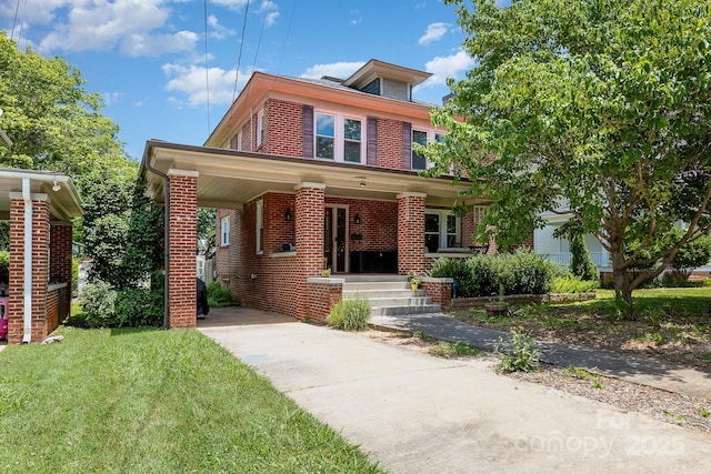 206 Mitchell Ave, Salisbury, NC 28144 - american foursquare style home with brick siding, driveway, covered porch, and a front lawn