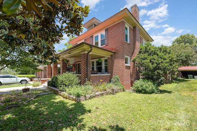 206 Mitchell Ave, Salisbury, NC 28144 - view of front of home with a chimney, brick siding, a front lawn, and a porch