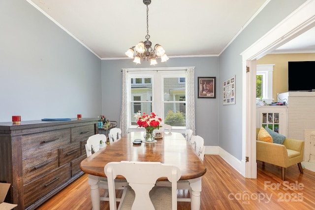 206 Mitchell Ave, Salisbury, NC 28144 - dining room featuring a chandelier, light wood-style flooring, and ornamental molding