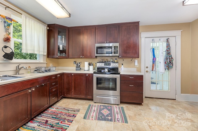 206 Mitchell Ave, Salisbury, NC 28144 - kitchen with stainless steel appliances, light countertops, and glass insert cabinets